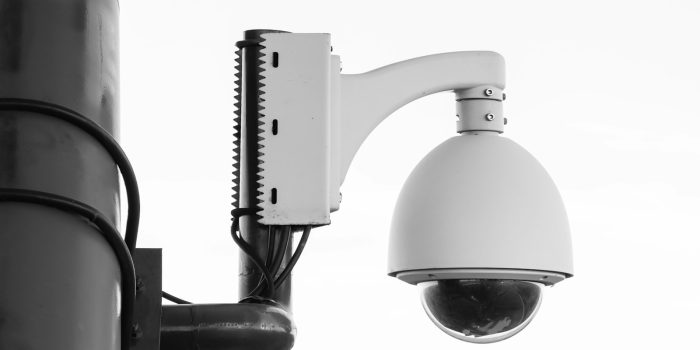 white security camera on post